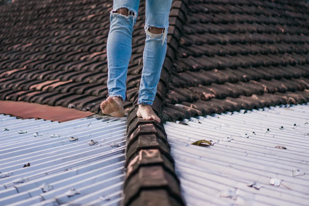 Man Walking Roof Commercial Rubber Roofing Advantages